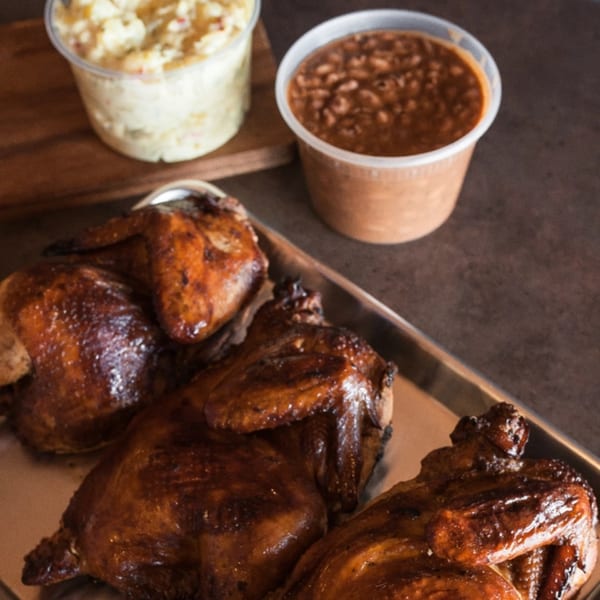 Meyer's Elgin Smokehouse BBQ chicken with sides of potato salad and baked beans.